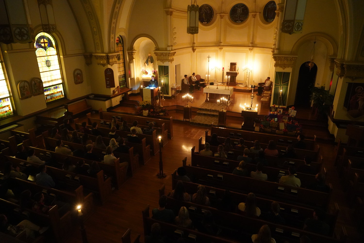 Father Daniel Merz offers Mass by candlelight the evening of Nov. 2, the Commemoration of the Faithful Departed (All Souls) in Sacred Heart Church in Columbia.